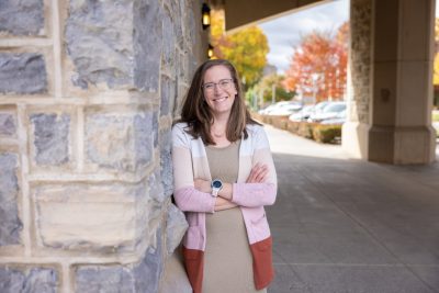 Corinne Guimont stands underneath the Torgersen Bridge on a fall sunny day.